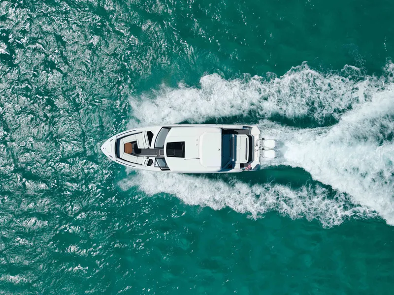 Slide: The Image of Aerial view of 2024 Cobalt R35 boat on turquoise water. - 4