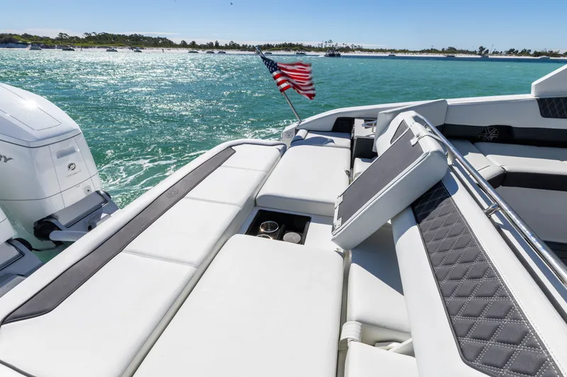 Slide: The Image of Luxurious 2024 Cobalt R35 boat on open water with American flag. - 43