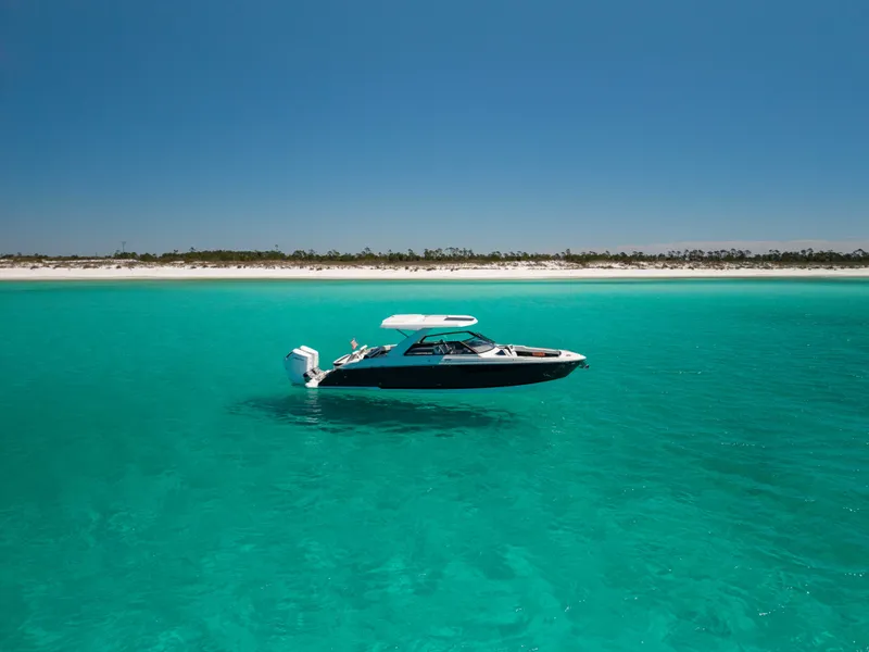 Slide: The Image of 2024 Cobalt R35 boat on turquoise water near sandy beach. - 8