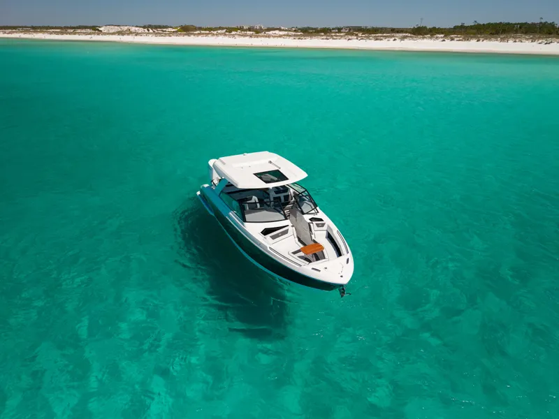 Slide: The Image of 2024 Cobalt R35 boat on turquoise water near coastline. - 9
