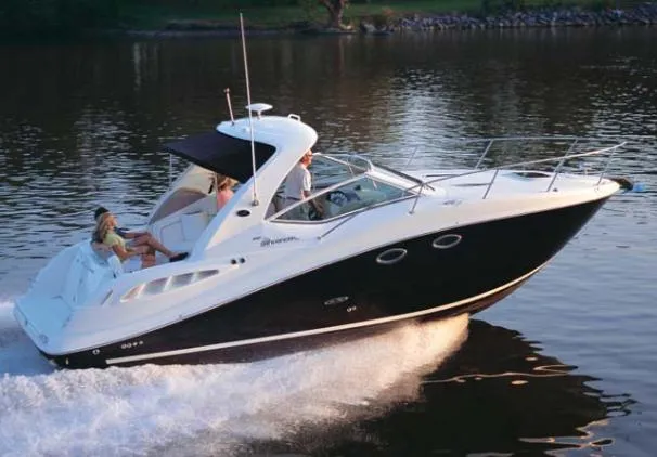 The Image of 2007 Sea Ray 290 Sundancer docked on a lift by the water. - 0