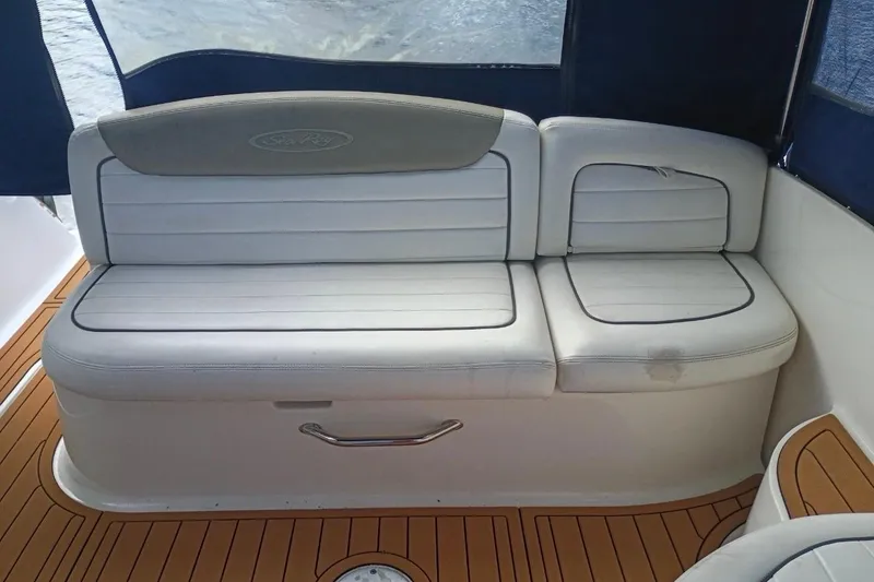 Slide: The Image of White leather seating on 2007 Sea Ray 290 Sundancer boat with teak flooring. - 4