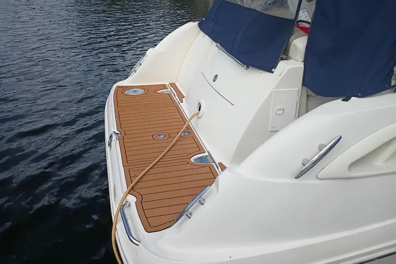 Slide: The Image of 2007 Sea Ray 290 Sundancer boat with teak swim platform on calm water. - 5