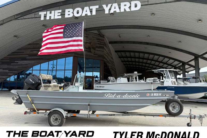 The Image of 2004 Tims Flat Boat 18x60 with American flag at The Boat Yard. - 1