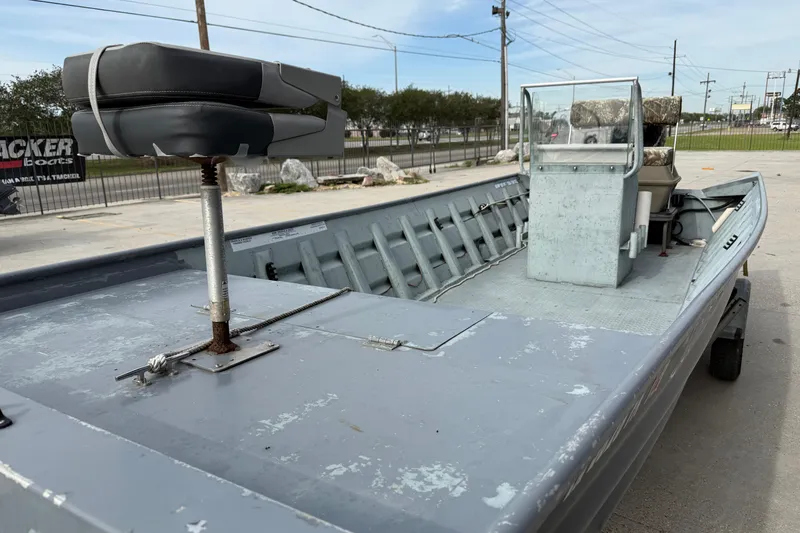 Slide: The Image of 2004 Tims Flat Boat 18x60, gray, with seating and console, parked outdoors. - 5