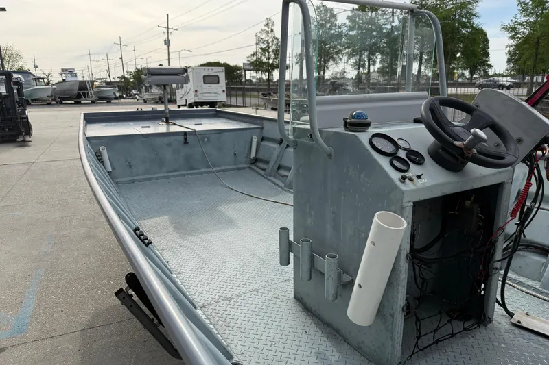 Slide: The Image of 2004 Tims Flat Boat 18x60 with steering console, docked outdoors. - 8