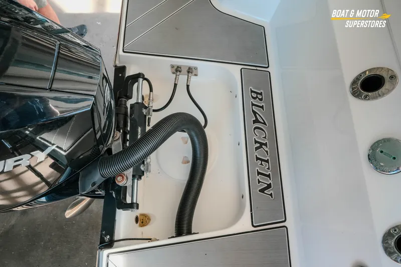 Slide: The Image of 2022 Blackfin 222 CC boat engine area with branding and motor details. - 10