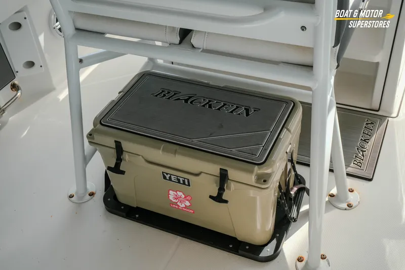 Slide: The Image of 2022 Blackfin 222 CC boat interior with Yeti cooler and branded mat. - 13
