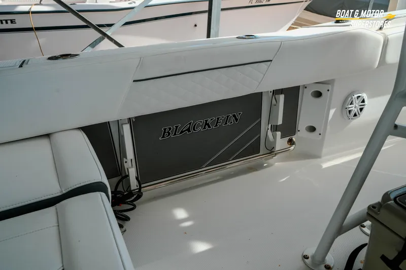 Slide: The Image of 2022 Blackfin 222 CC boat interior with branded storage compartment and seating. - 14