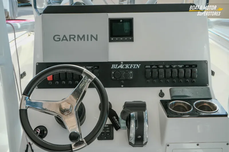 Slide: The Image of 2022 Blackfin 222 CC boat dashboard with Garmin navigation and control panel. - 16