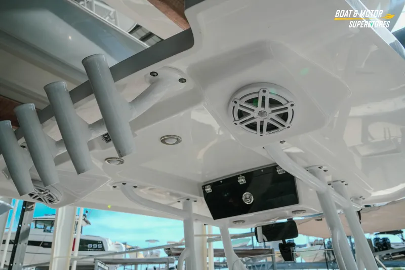 Slide: The Image of 2022 Blackfin 222 CC boat interior with rod holders and speakers, showcasing modern design. - 18