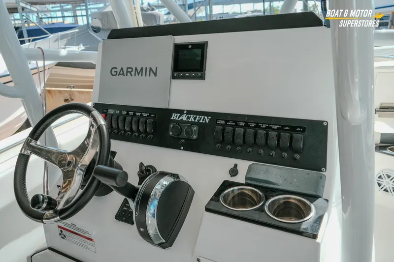Slide: The Image of 2022 Blackfin 222 CC boat dashboard with Garmin navigation system and steering wheel. - 20