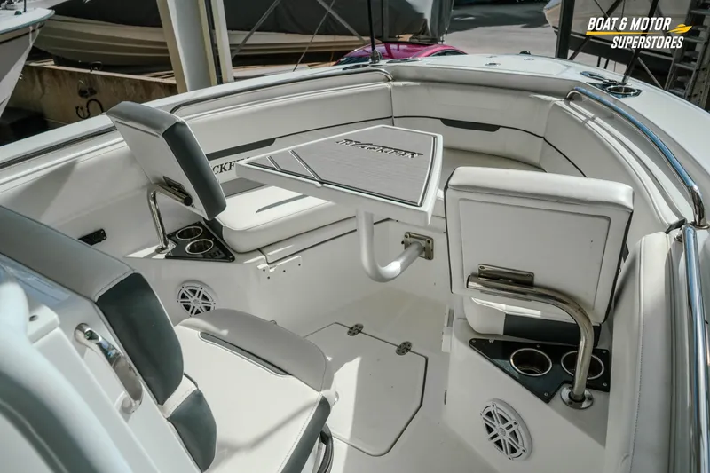 Slide: The Image of 2022 Blackfin 222 CC boat interior with seating and table setup. - 23