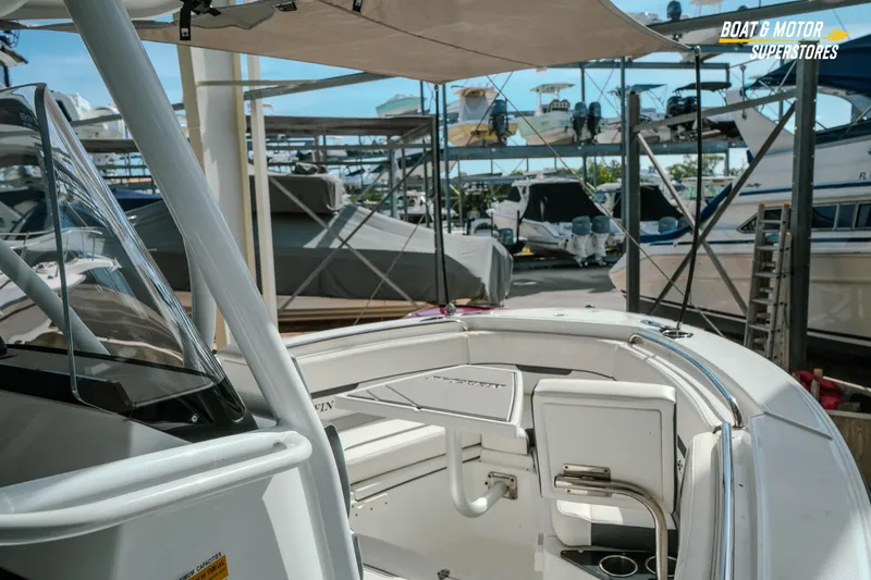 Slide: The Image of 2022 Blackfin 222 CC boat interior at marina with multiple boats in background. - 24