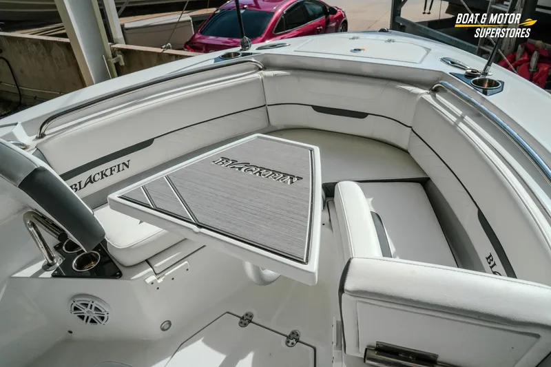Slide: The Image of 2022 Blackfin 222 CC boat interior with seating and table, showcasing luxury design. - 27