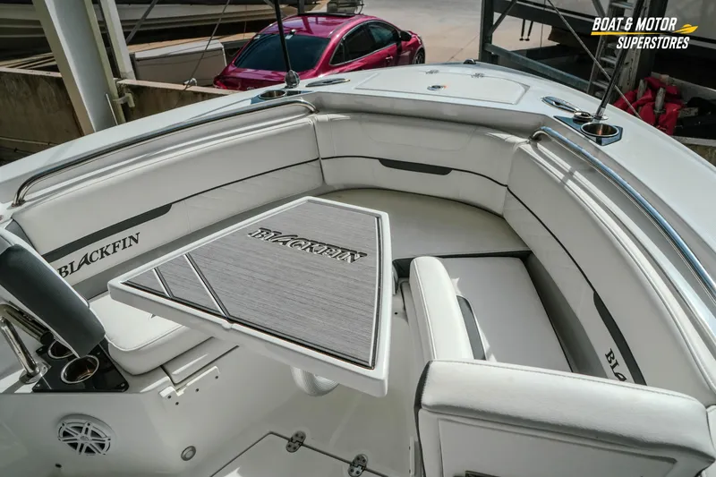 Slide: The Image of 2022 Blackfin 222 CC boat interior with seating and table, showcased at Boat & Motor Superstores. - 28