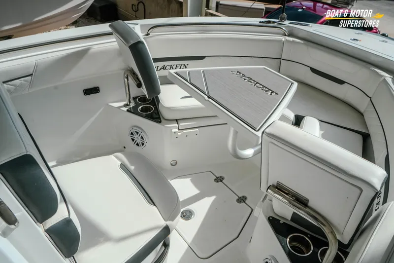 Slide: The Image of 2022 Blackfin 222 CC boat interior with seating and table, showcasing luxury design. - 29