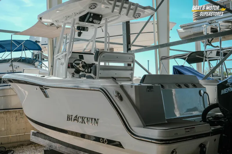 Slide: The Image of 2022 Blackfin 222 CC boat in marina, showcasing sleek design and modern features. - 3