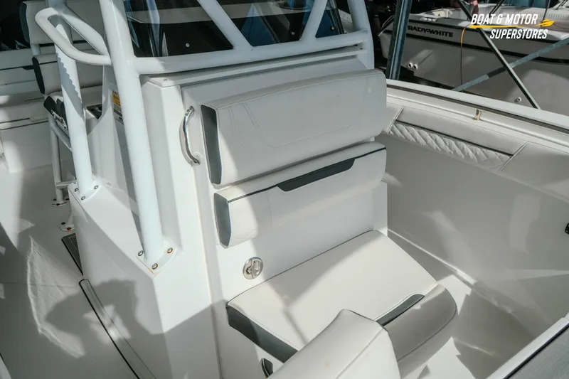 Slide: The Image of 2022 Blackfin 222 CC boat interior with white seating and console details. - 31