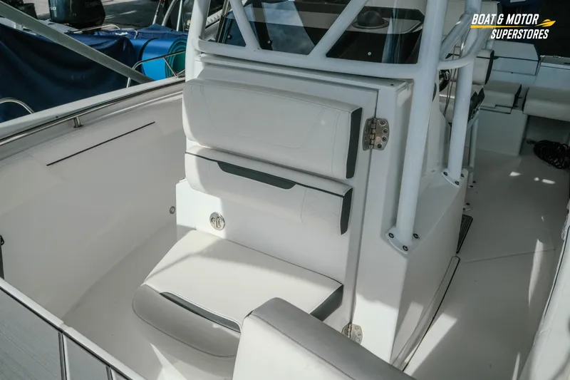 Slide: The Image of 2022 Blackfin 222 CC boat interior with white seating and storage compartments. - 32
