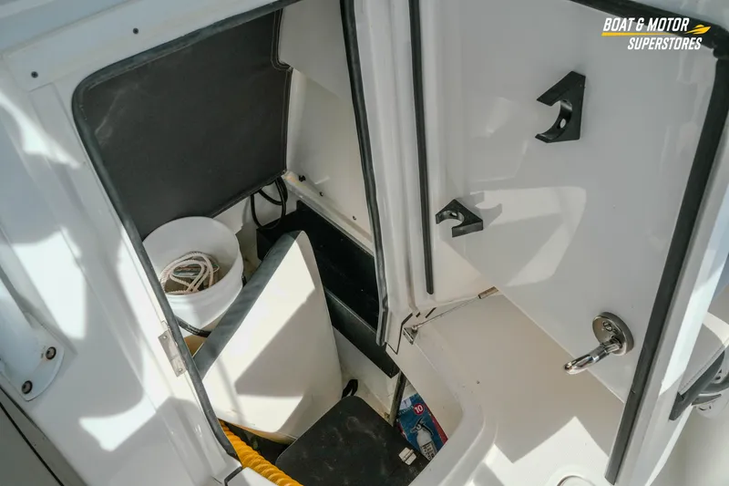 Slide: The Image of 2022 Blackfin 222 CC boat storage compartment with ropes and equipment. - 33