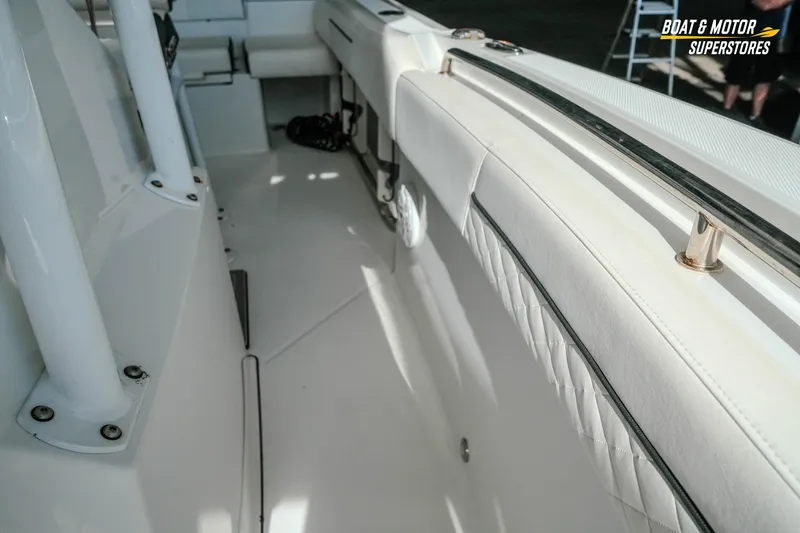 Slide: The Image of 2022 Blackfin 222 CC boat interior with white seating and stainless steel railings. - 36