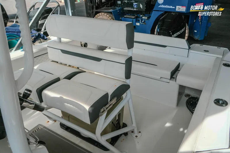 Slide: The Image of 2022 Blackfin 222 CC boat interior with white seating and storage compartments. - 37