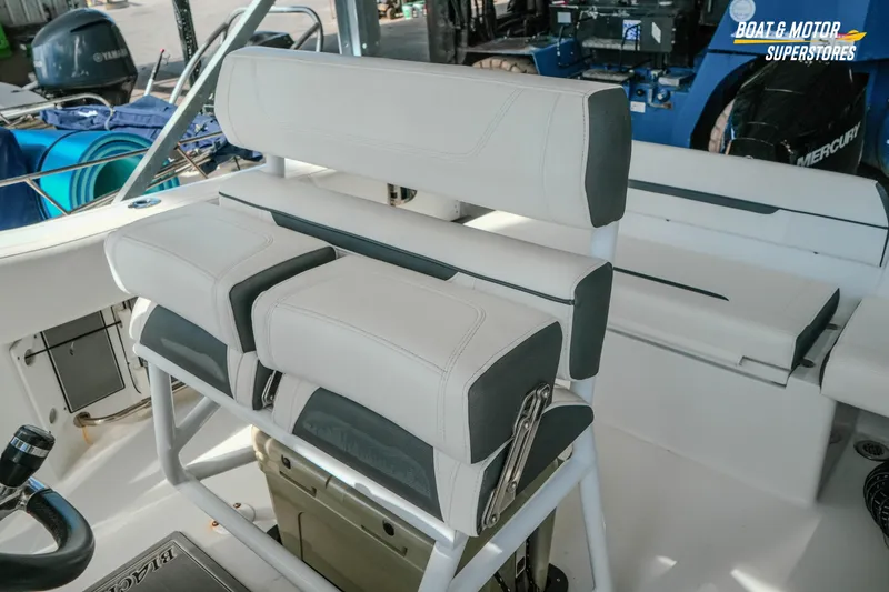 Slide: The Image of 2022 Blackfin 222 CC boat interior with white cushioned seating and steering wheel. - 40