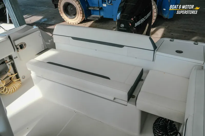 Slide: The Image of 2022 Blackfin 222 CC boat interior with white seating and Mercury engine. - 41