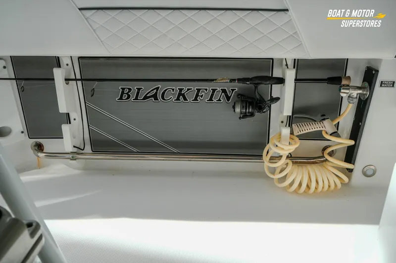 Slide: The Image of 2022 Blackfin 222 CC boat interior with fishing rod holder and fresh water hose. - 47