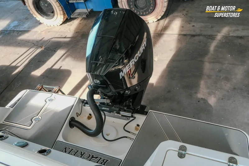Slide: The Image of 2022 Blackfin 222 CC boat with Mercury outboard motor in a showroom. - 48