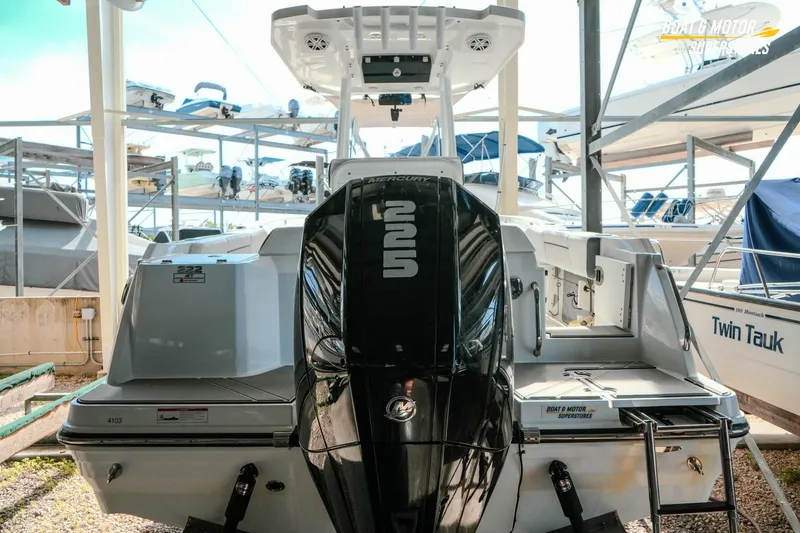 Slide: The Image of 2022 Blackfin 222 CC boat with Mercury engine in a marina storage area. - 49