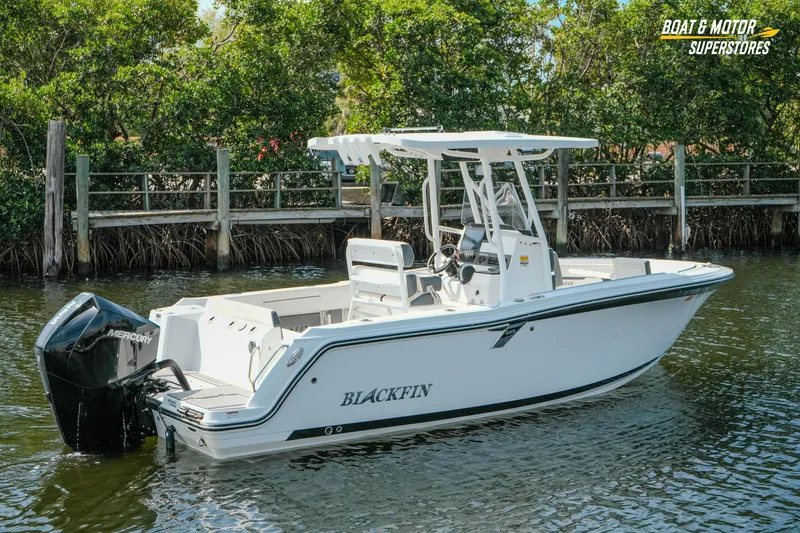 Slide: The Image of 2022 Blackfin 222 CC boat on water, featuring sleek design and Mercury engine. - 53