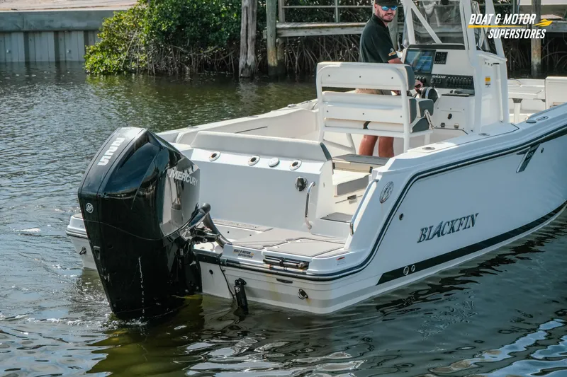 Slide: The Image of 2022 Blackfin 222 CC boat with Mercury engine on water, featuring sleek design. - 55