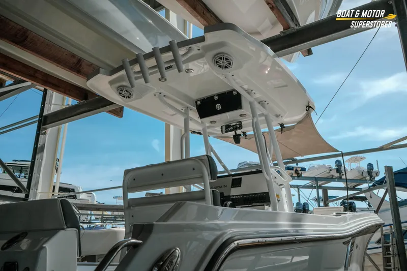 Slide: The Image of 2022 Blackfin 222 CC boat with T-top and electronics, displayed at a dealership. - 6