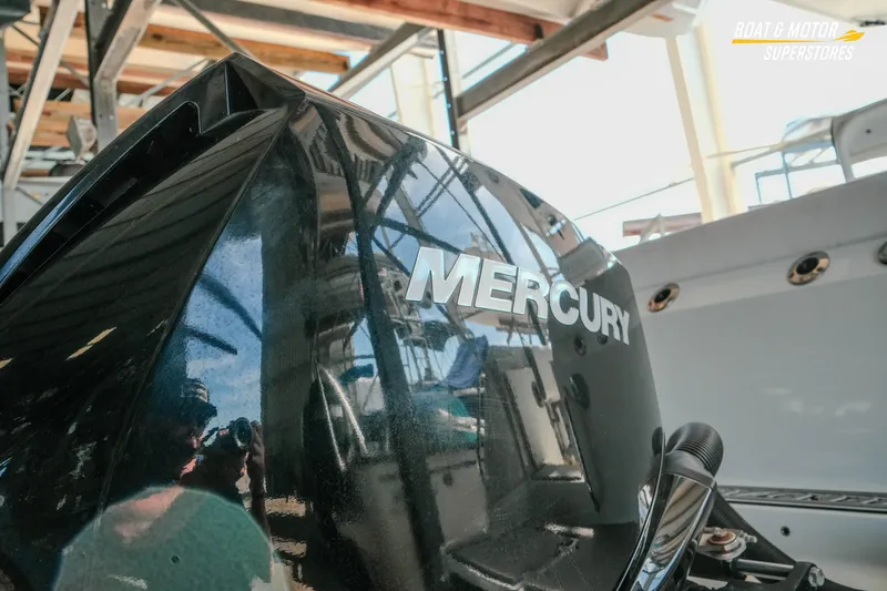 Slide: The Image of 2022 Blackfin 222 CC with Mercury engine in a boat showroom. - 8