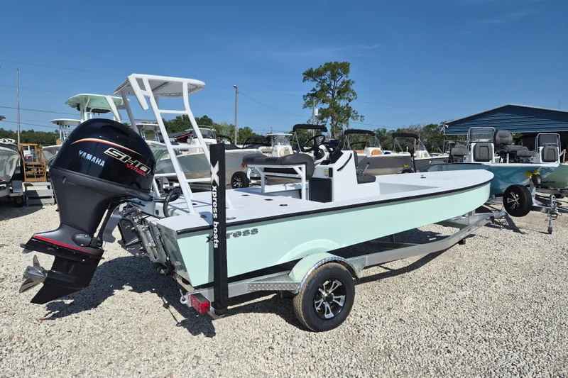 The Image of 2026 Xpress Skiff 185 boat with Yamaha engine on display in a gravel lot. - 1