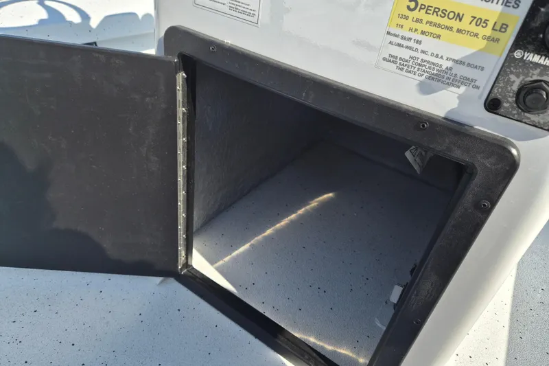 Slide: The Image of Open storage compartment on 2026 Xpress Skiff 185 boat. - 13