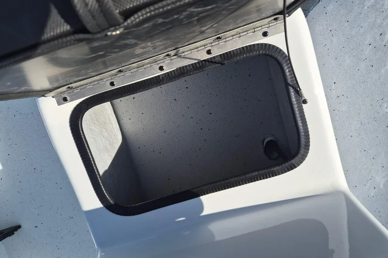 Slide: The Image of Open storage compartment on 2026 Xpress Skiff 185 boat deck. - 16