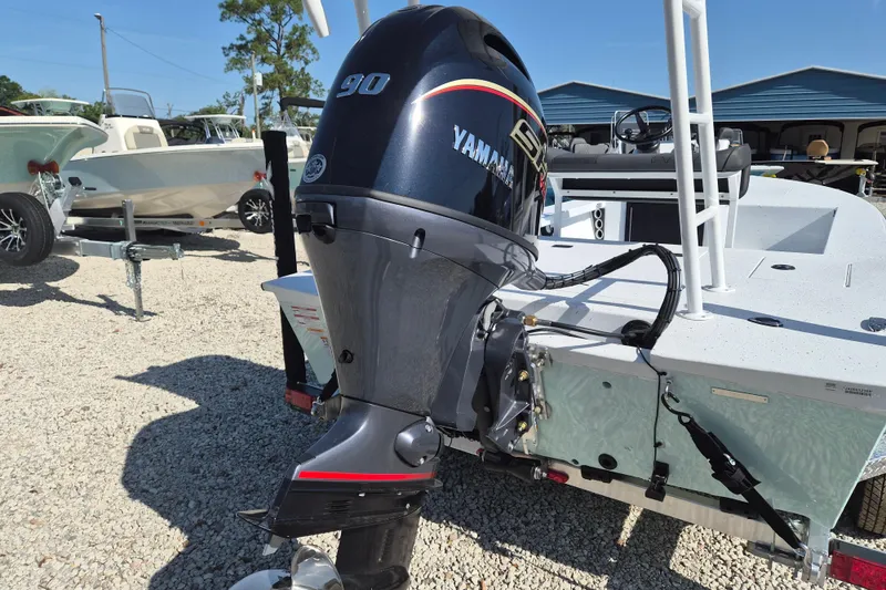 Slide: The Image of 2026 Xpress Skiff 185 with Yamaha 90 outboard motor in a boatyard. - 3