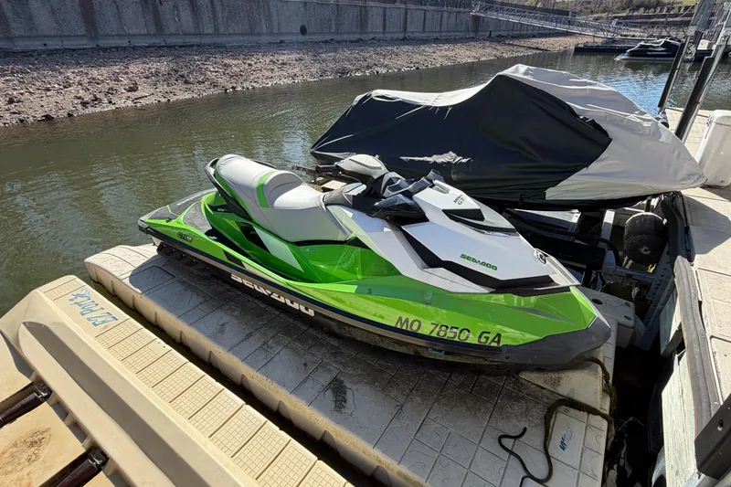 Slide: The Image of 2014 Sea-Doo GTI 130 jet ski docked on a platform by the water. - 12