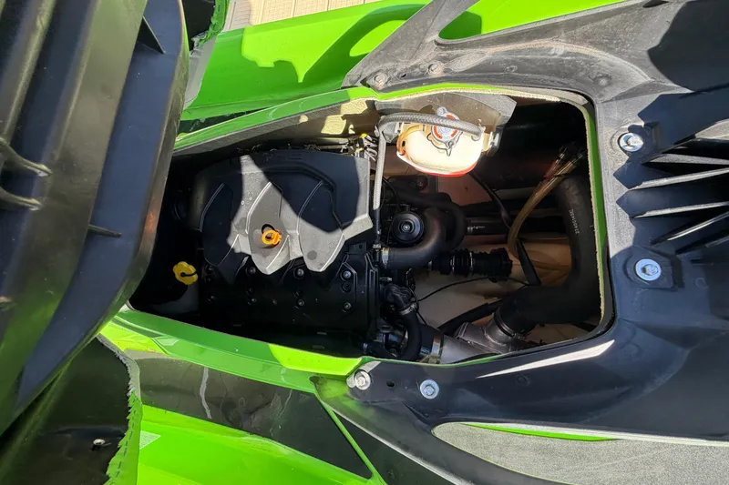 Slide: The Image of 2014 Sea-Doo GTI 130 engine compartment, showcasing internal components and vibrant green exterior. - 16