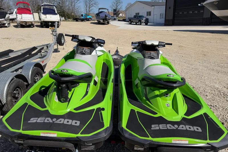 Slide: The Image of Two green 2014 Sea-Doo GTI 130 jet skis parked on a trailer. - 5