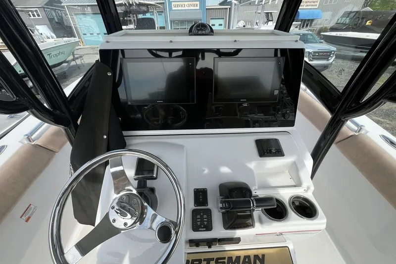 Slide: The Image of 2020 Sportsman Open 252 Center Console dashboard with steering wheel and dual displays. - 12