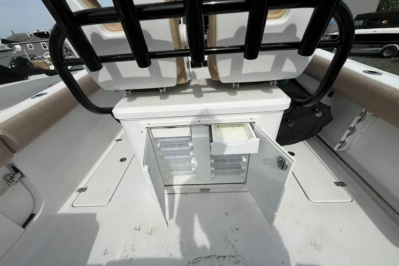 Slide: The Image of 2020 Sportsman Open 252 Center Console boat with open storage compartment and seating. - 14