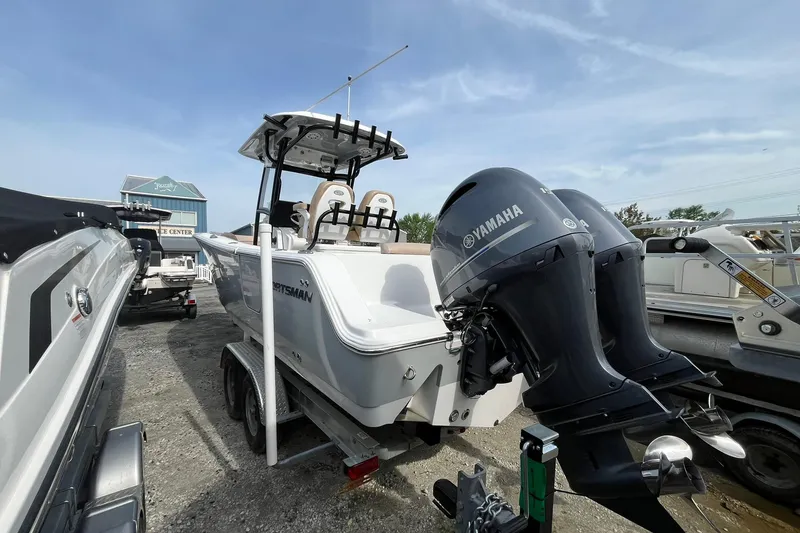 Slide: The Image of 2020 Sportsman Open 252 Center Console boat with dual Yamaha engines on a trailer. - 3