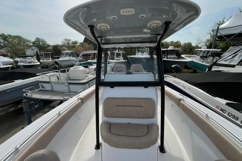 Slide: The Image of 2020 Sportsman Open 252 Center Console boat in marina, surrounded by other vessels. - 6