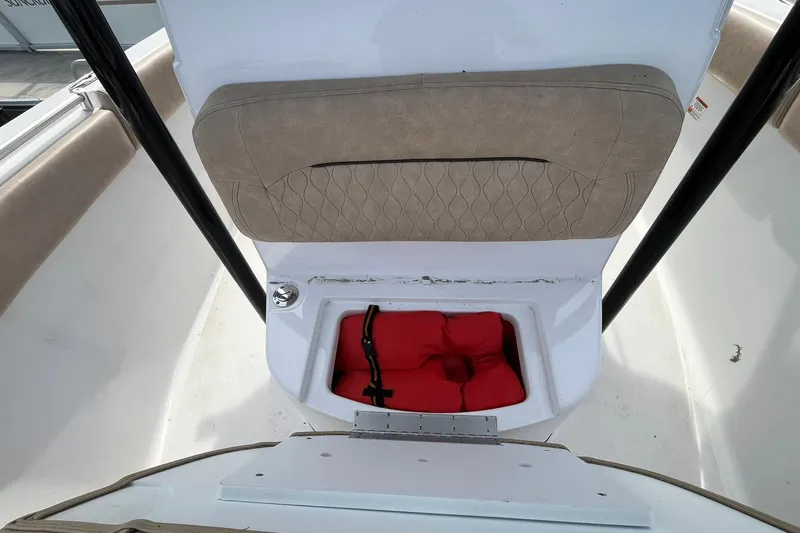Slide: The Image of 2020 Sportsman Open 252 Center Console boat with storage compartment and red life jacket. - 7