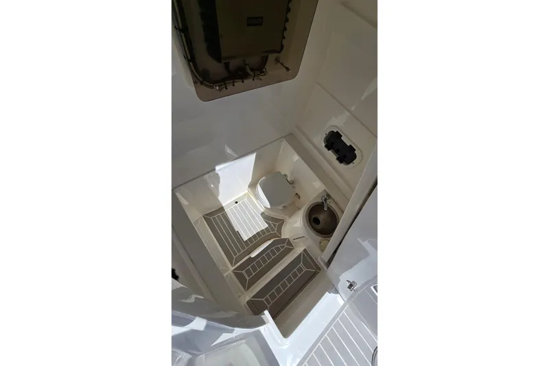 Slide: The Image of Interior view of 2007 Intrepid 323 Open boat, featuring steps and a compact sink area. - 12