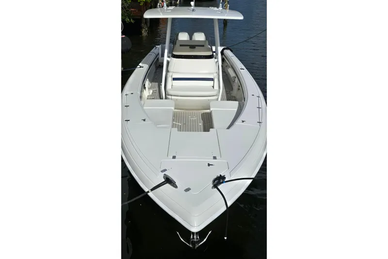 Slide: The Image of 2007 Intrepid 323 Open boat with sleek design, docked on calm water. - 2